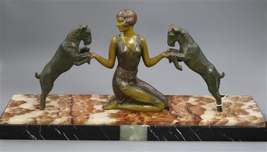 An Art Deco patinated spelter model of a girl with two goats, onyx base, length 52cm